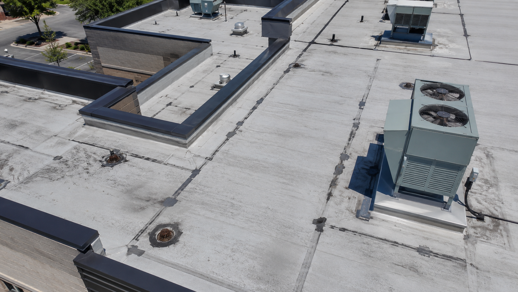 Oblique aerial view of a commercial rooftop inspection.